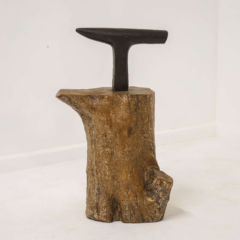 A nineteenth-century T-shaped wrought iron farriers anvil mounted into a natural carved fruitwood log trunk. View VI
