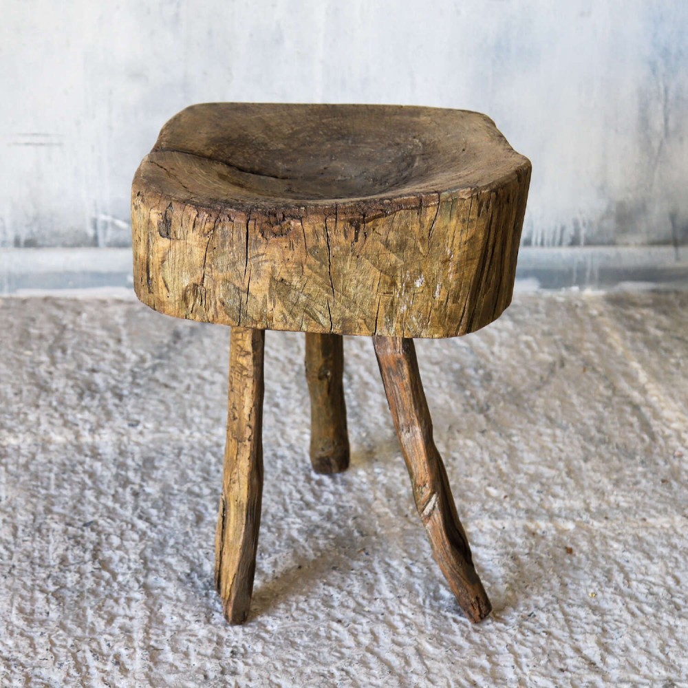 A 19th-century French elm chopping block featuring a heavy carved wooden top supported by three natural gnarled legs. View II
