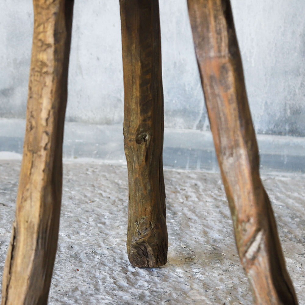 A 19th-century French elm chopping block featuring a heavy carved wooden top supported by three natural gnarled legs. View III