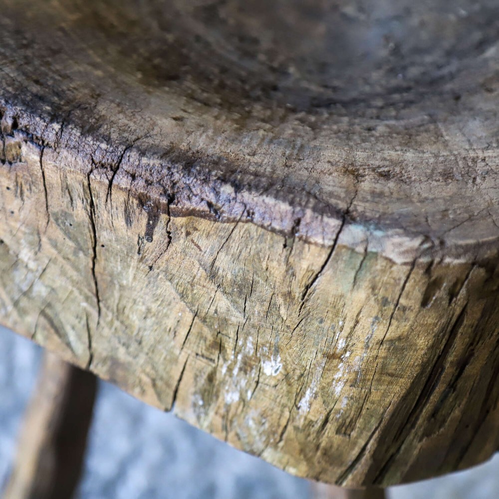 A 19th-century French elm chopping block featuring a heavy carved wooden top supported by three natural gnarled legs. View IV
