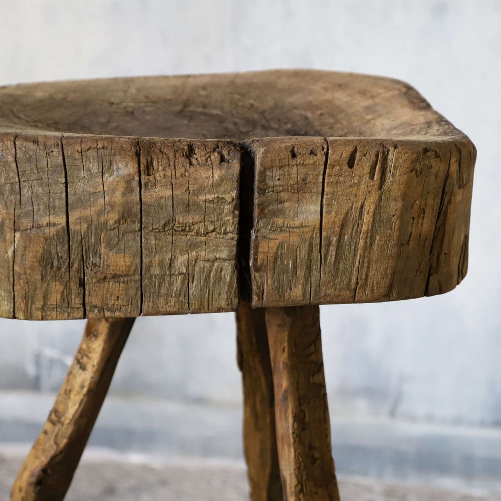 A 19th-century French elm chopping block featuring a heavy carved wooden top supported by three natural gnarled legs. View VI