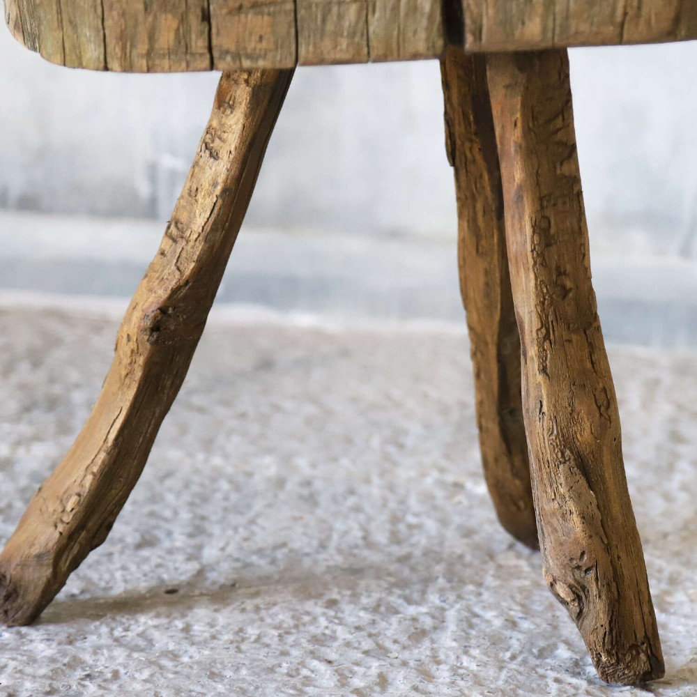 A 19th-century French elm chopping block featuring a heavy carved wooden top supported by three natural gnarled legs. View VIII