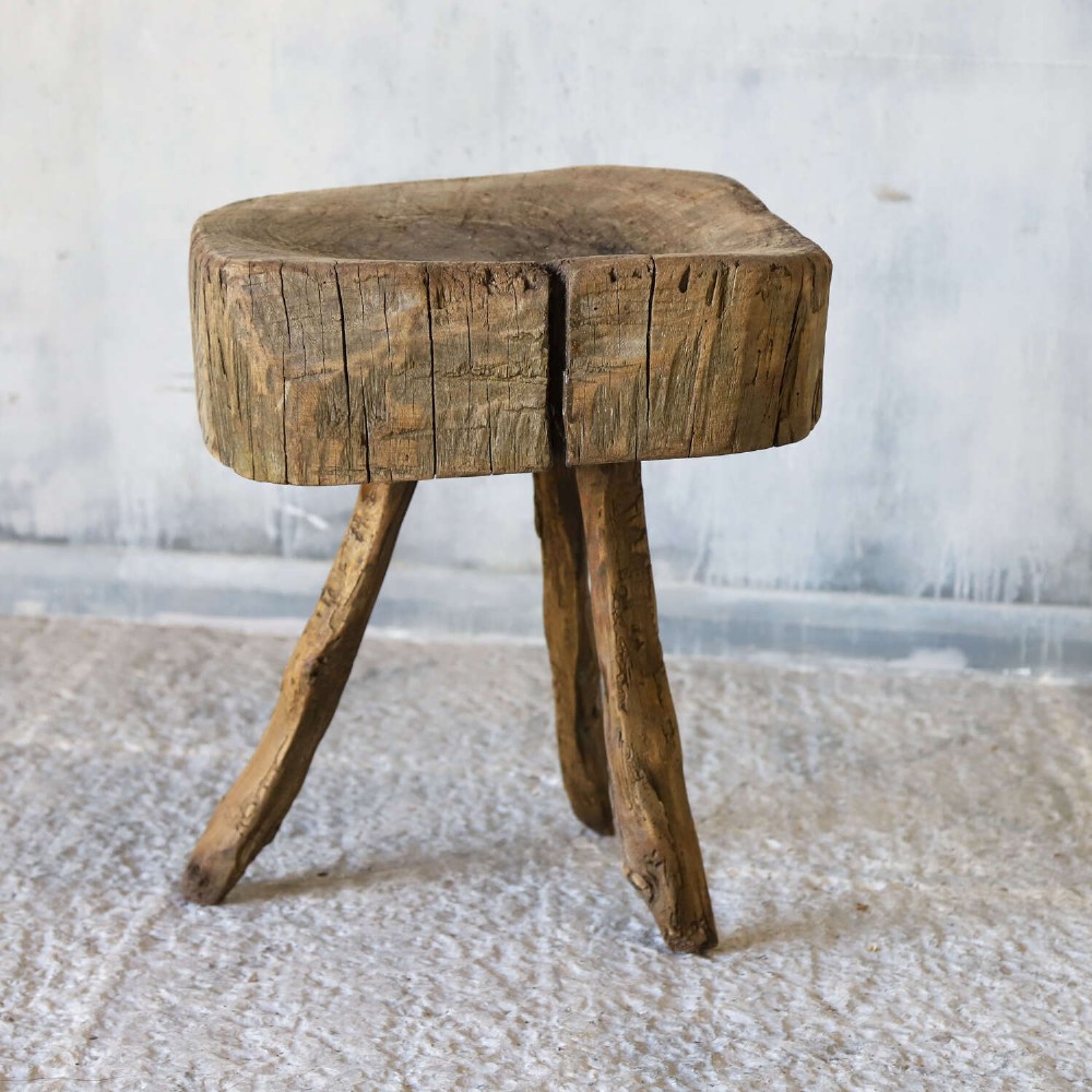 A 19th-century French elm chopping block featuring a heavy carved wooden top supported by three natural gnarled legs. View IX