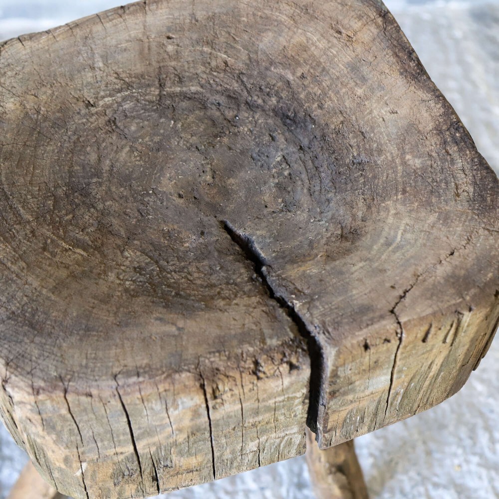 A 19th-century French elm chopping block featuring a heavy carved wooden top supported by three natural gnarled legs. View XI