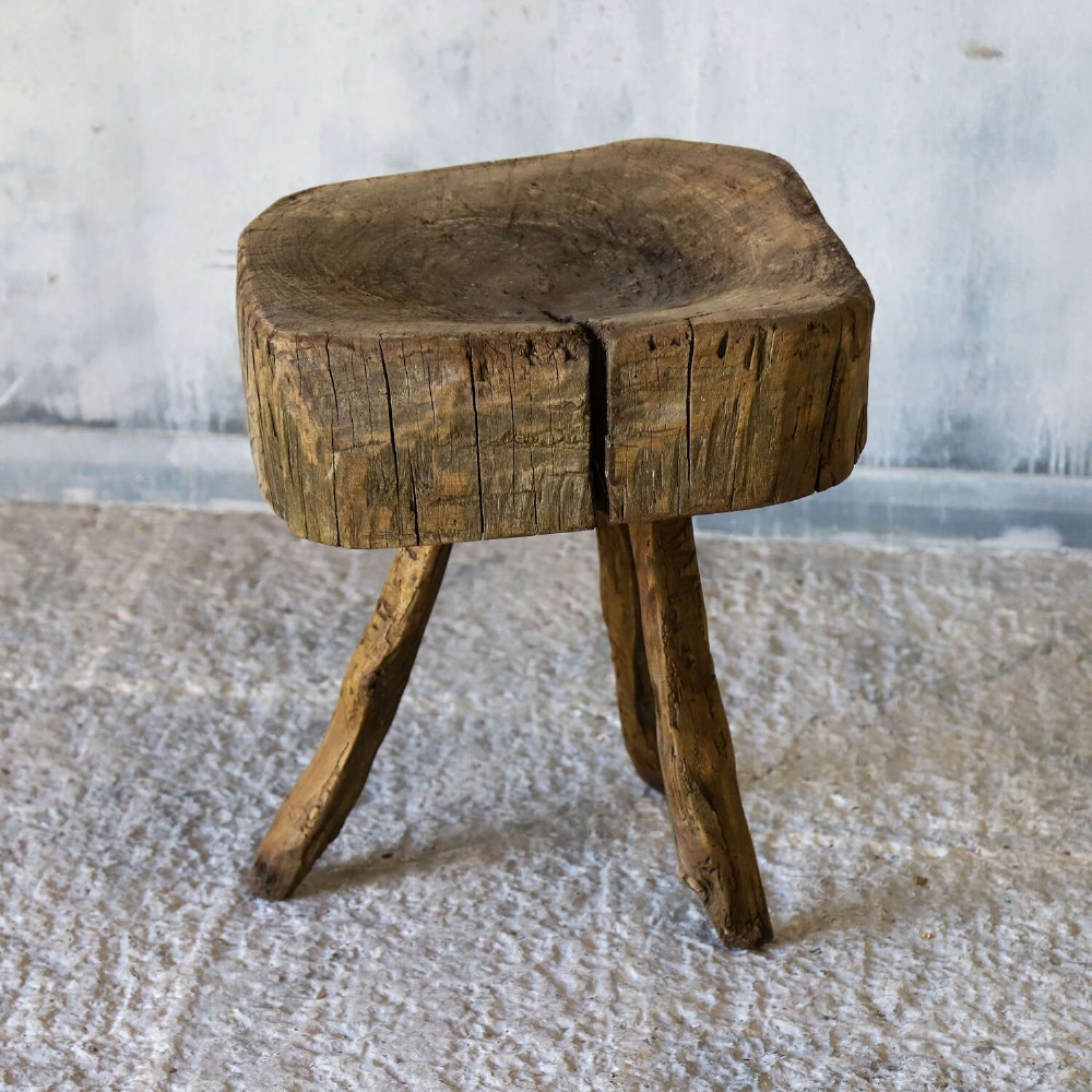 A 19th-century French elm chopping block featuring a heavy carved wooden top supported by three natural gnarled legs. View XII