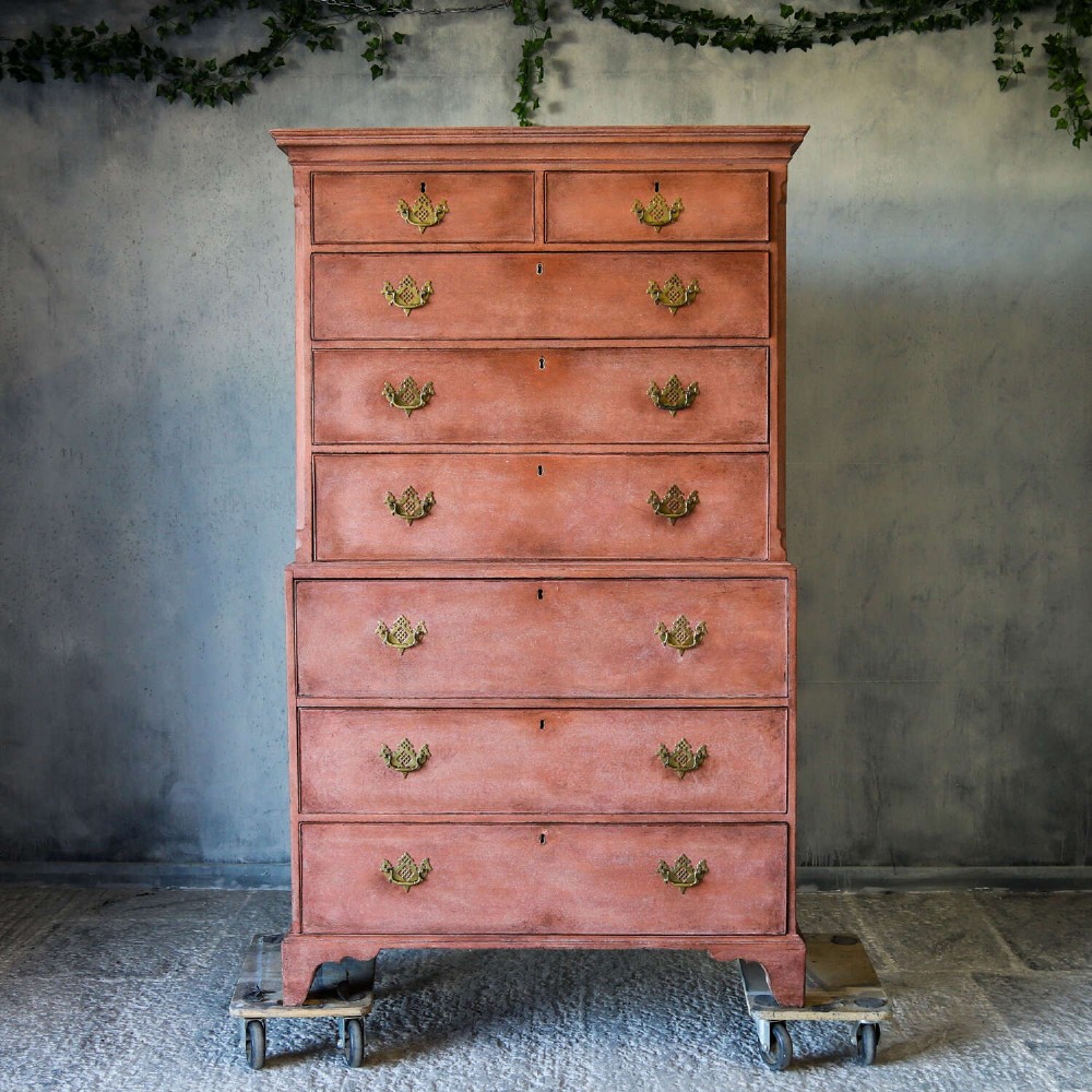 An eighteenth-century Georgian chest on chest with a distressed terracotta painted finish, brass pierced handles, and bracket feet. View II