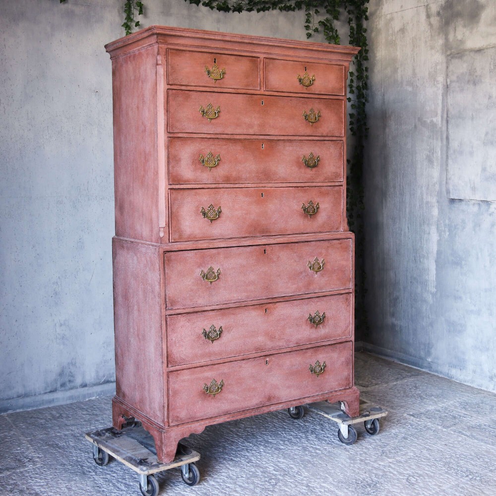 An eighteenth-century Georgian chest on chest with a distressed terracotta painted finish, brass pierced handles, and bracket feet. View III