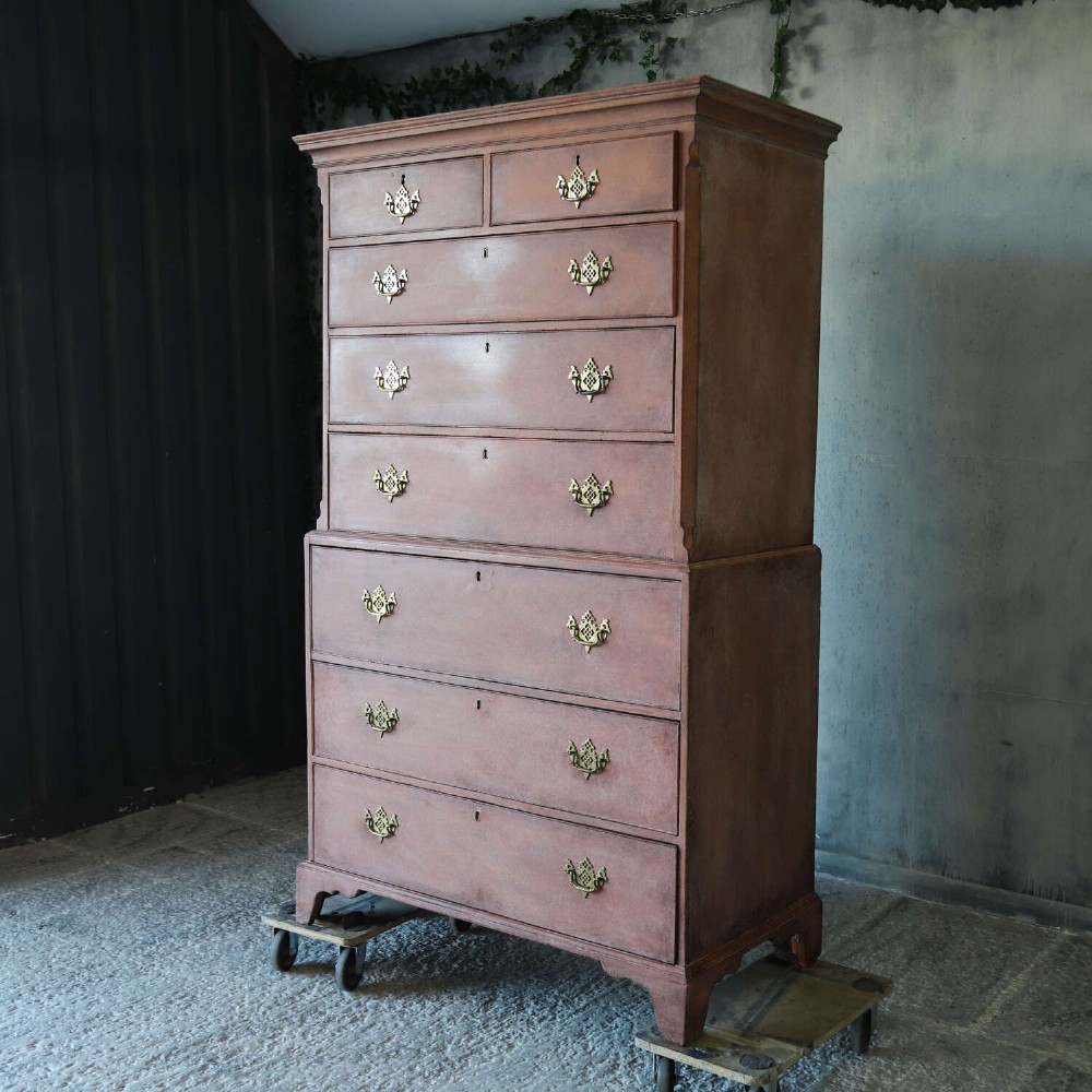 An eighteenth-century Georgian chest on chest with a distressed terracotta painted finish, brass pierced handles, and bracket feet. View IV