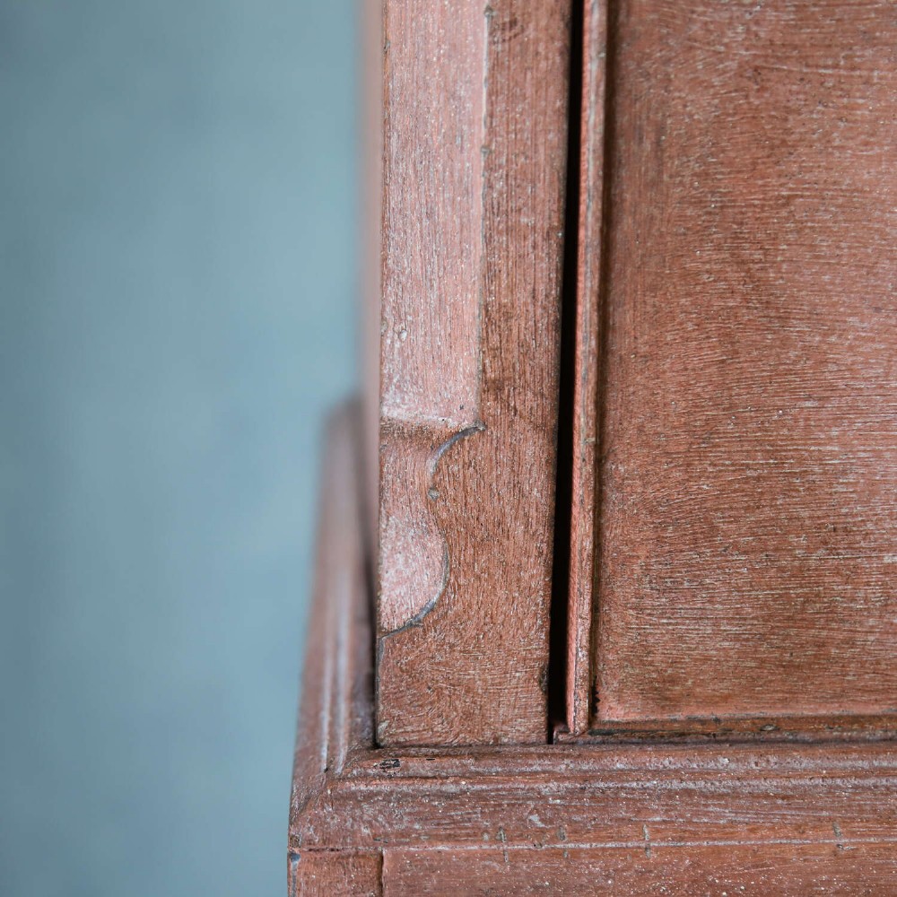An eighteenth-century Georgian chest on chest with a distressed terracotta painted finish, brass pierced handles, and bracket feet. View VII
