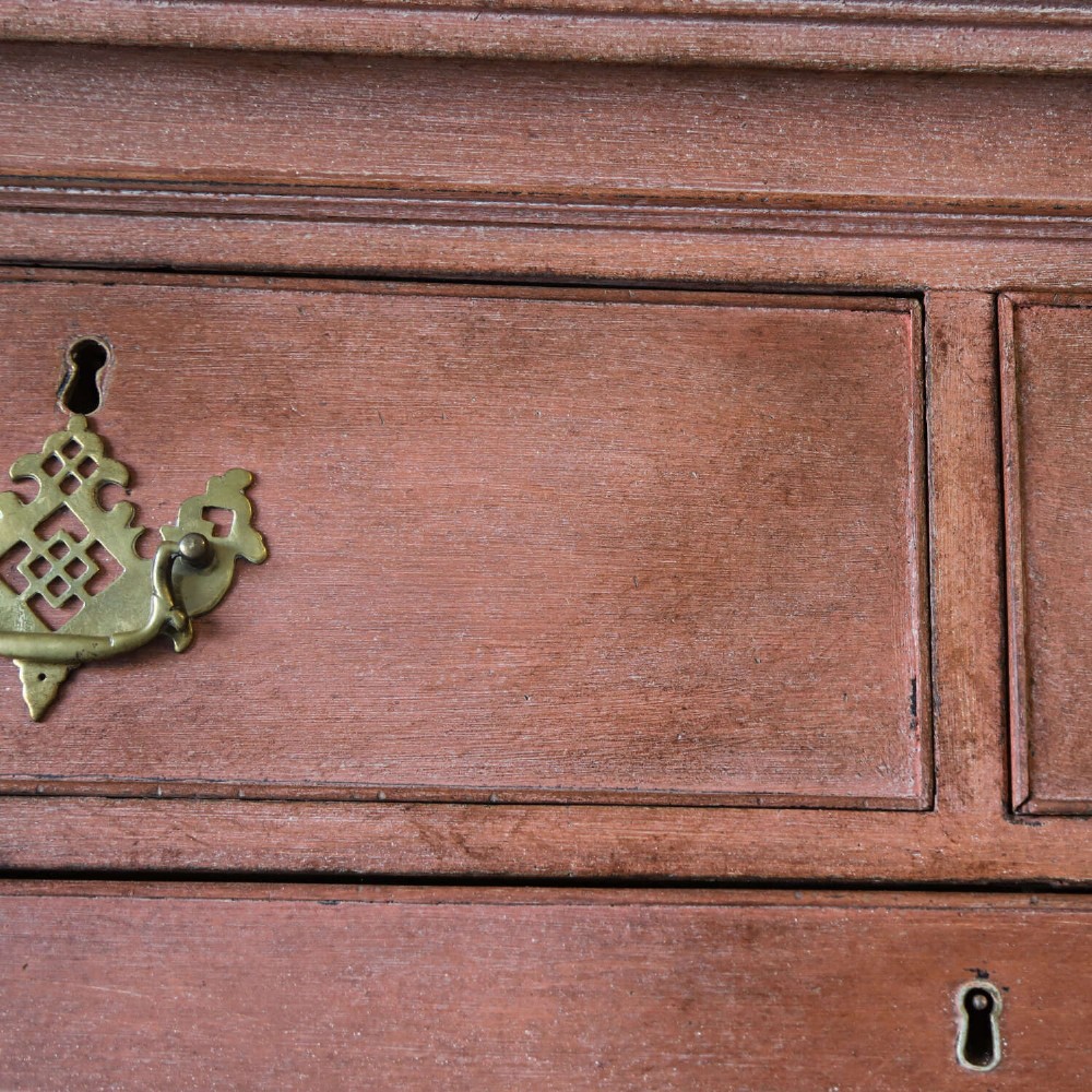 An eighteenth-century Georgian chest on chest with a distressed terracotta painted finish, brass pierced handles, and bracket feet. View VIII