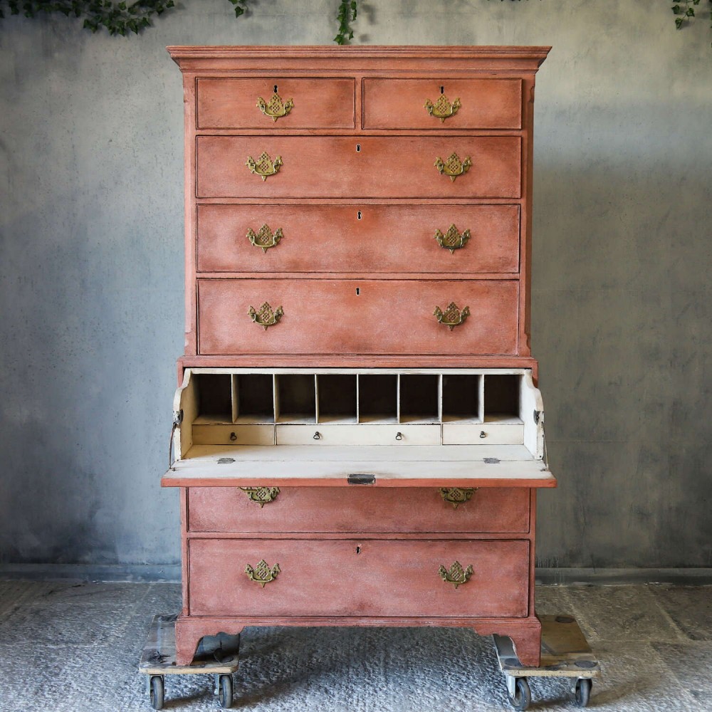 An eighteenth-century Georgian chest on chest with a distressed terracotta painted finish, brass pierced handles, and bracket feet. View IX
