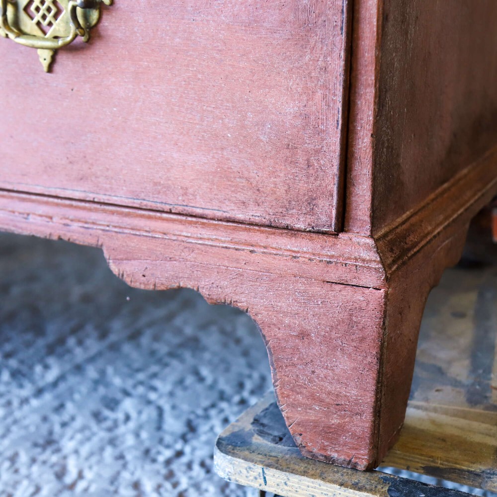 An eighteenth-century Georgian chest on chest with a distressed terracotta painted finish, brass pierced handles, and bracket feet. View XII