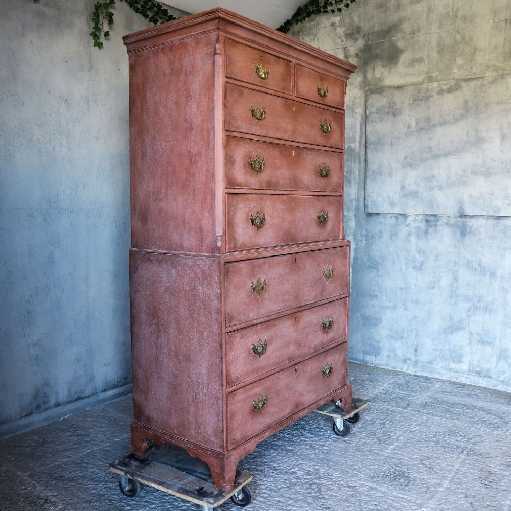 An eighteenth-century Georgian chest on chest with a distressed terracotta painted finish, brass pierced handles, and bracket feet. View XIII