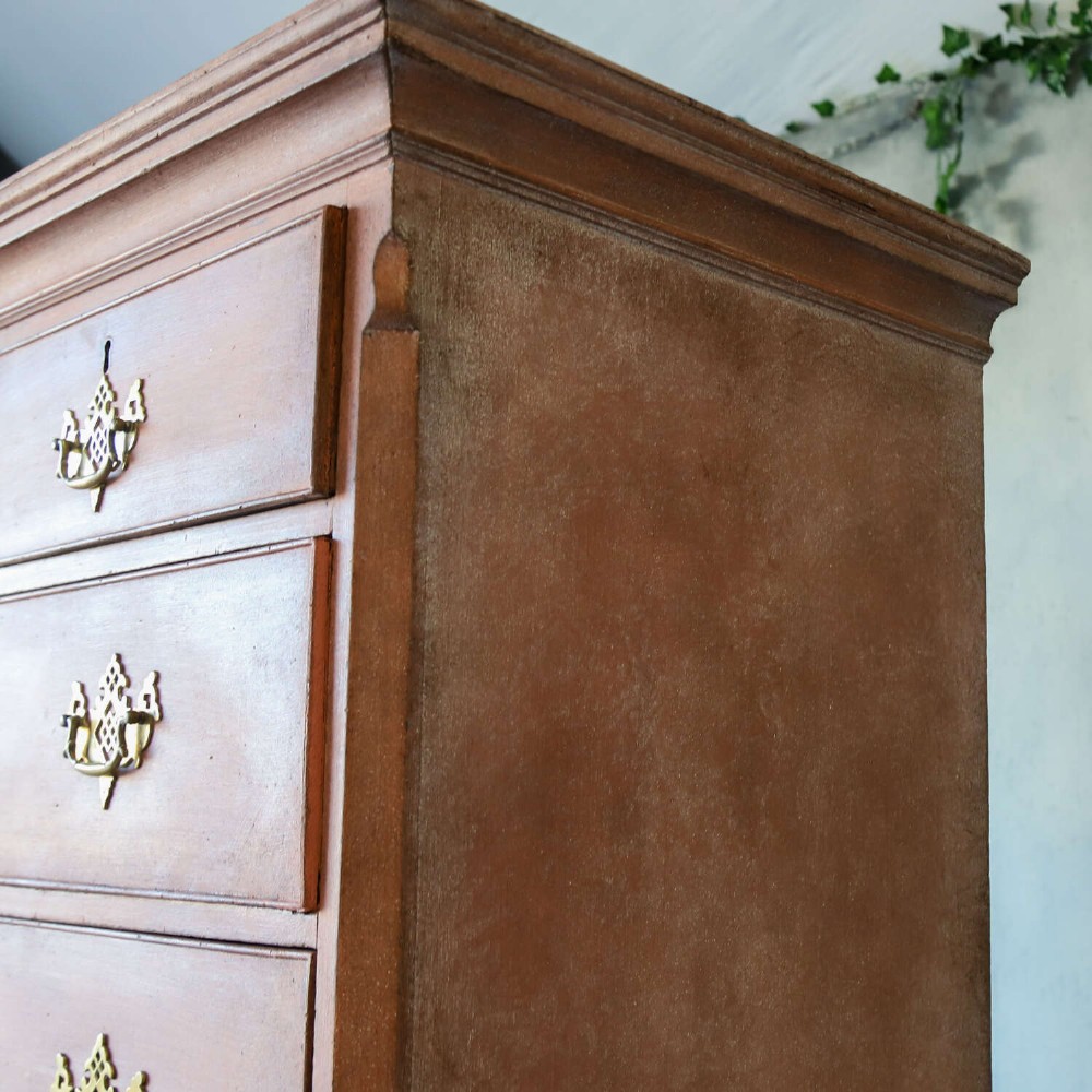 An eighteenth-century Georgian chest on chest with a distressed terracotta painted finish, brass pierced handles, and bracket feet. View XIV