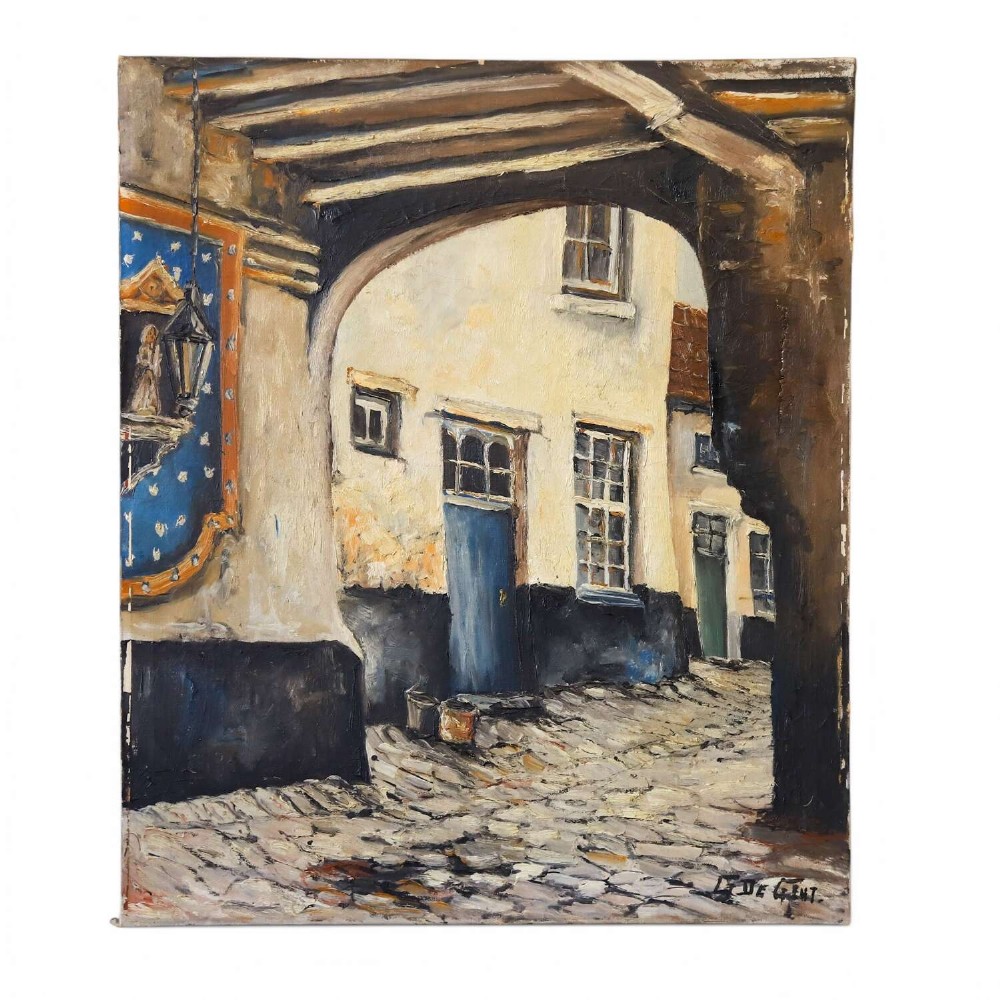 An oil painting on canvas depicting a Flemish cobbled street framed by a dark archway, featuring white plaster buildings and a blue door, signed by L. De Gent.