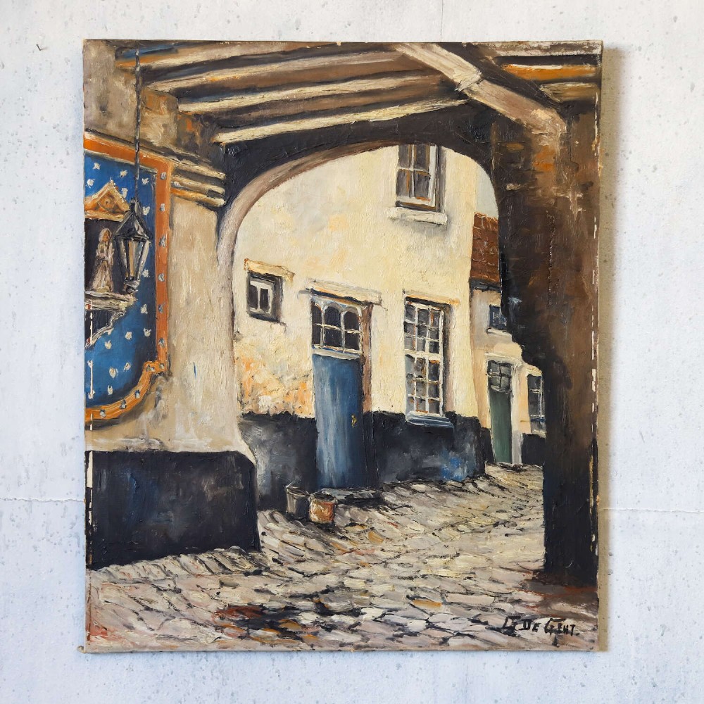 An oil painting on canvas depicting a Flemish cobbled street framed by a dark archway, featuring white plaster buildings and a blue door, signed by L. De Gent. View II