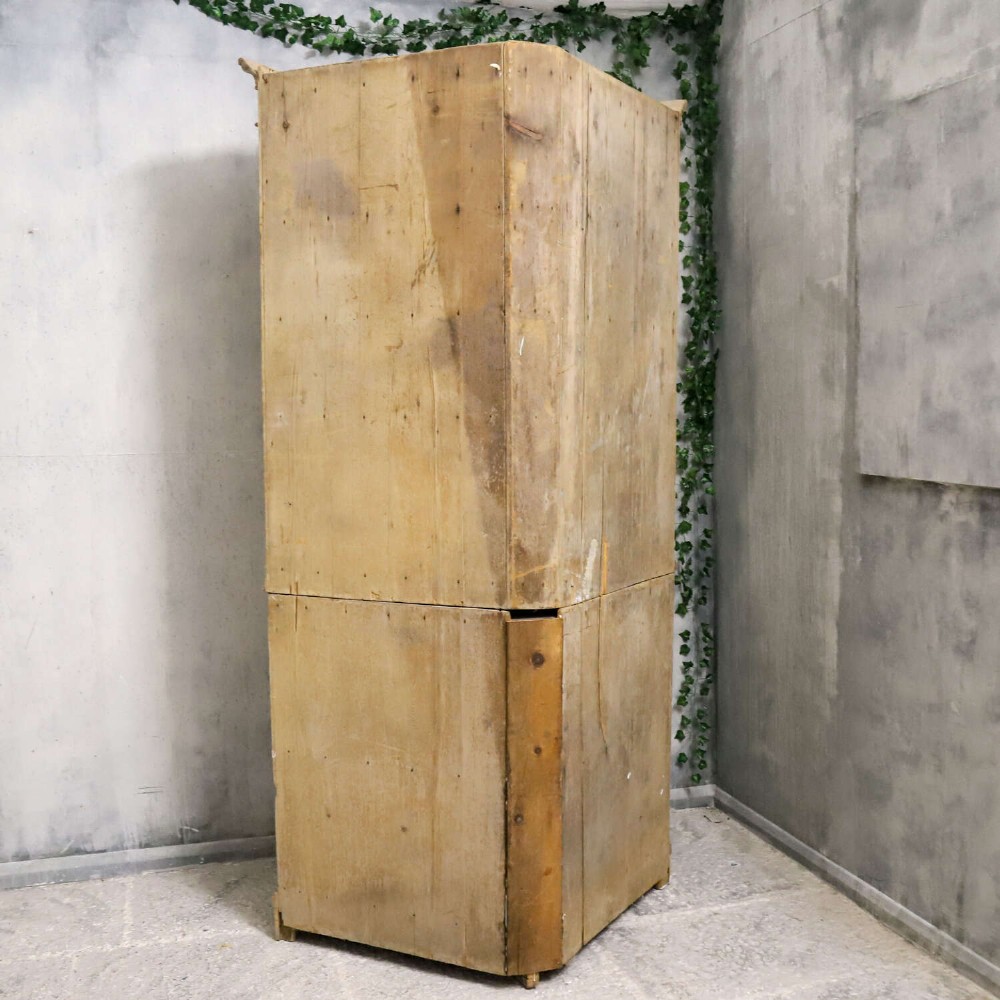 A nineteenth-century two-part pine corner cupboard featuring glazed upper doors and panelled lower doors with a shaped apron. View XV