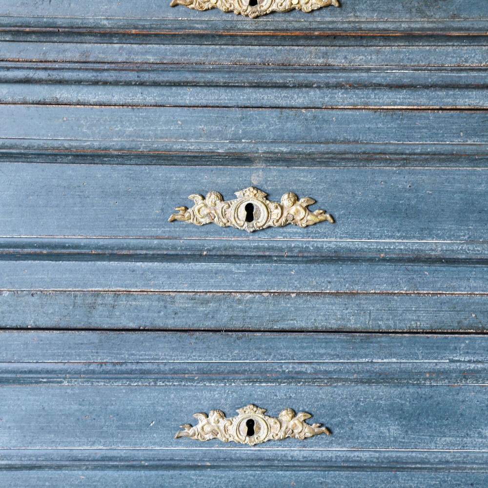 A late 19th-century French Louis XVI Revival chest of drawers painted in slate blue with four drawers featuring decorative brass hardware. View V