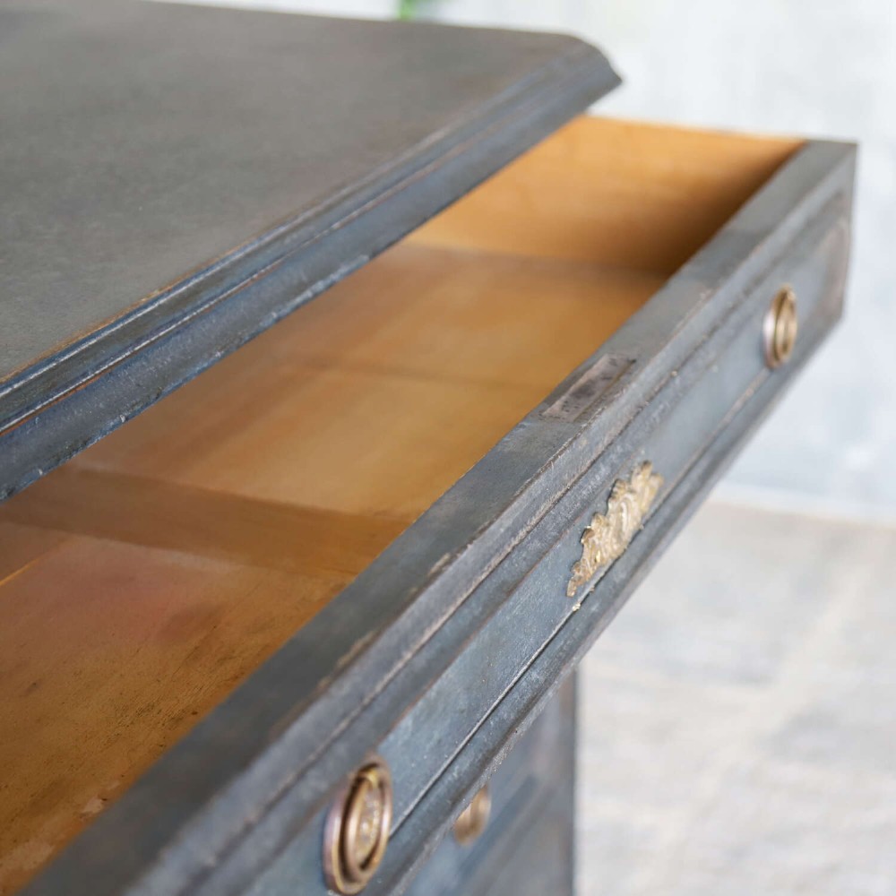 A late 19th-century French Louis XVI Revival chest of drawers painted in slate blue with four drawers featuring decorative brass hardware. View XV