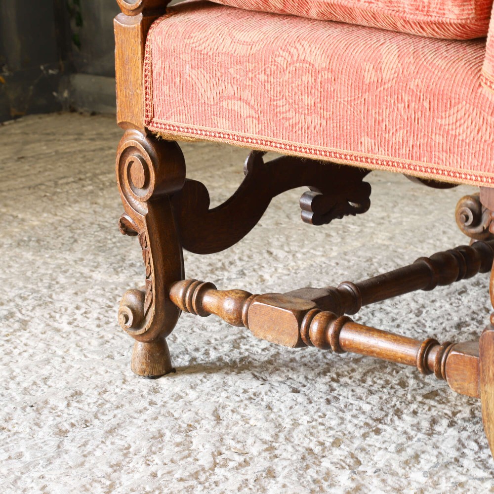 A pair of late nineteenth-century French Renaissance Revival oak armchairs upholstered in terracotta patterned fabric with carved scrolled stretchers and turned legs. View VIII