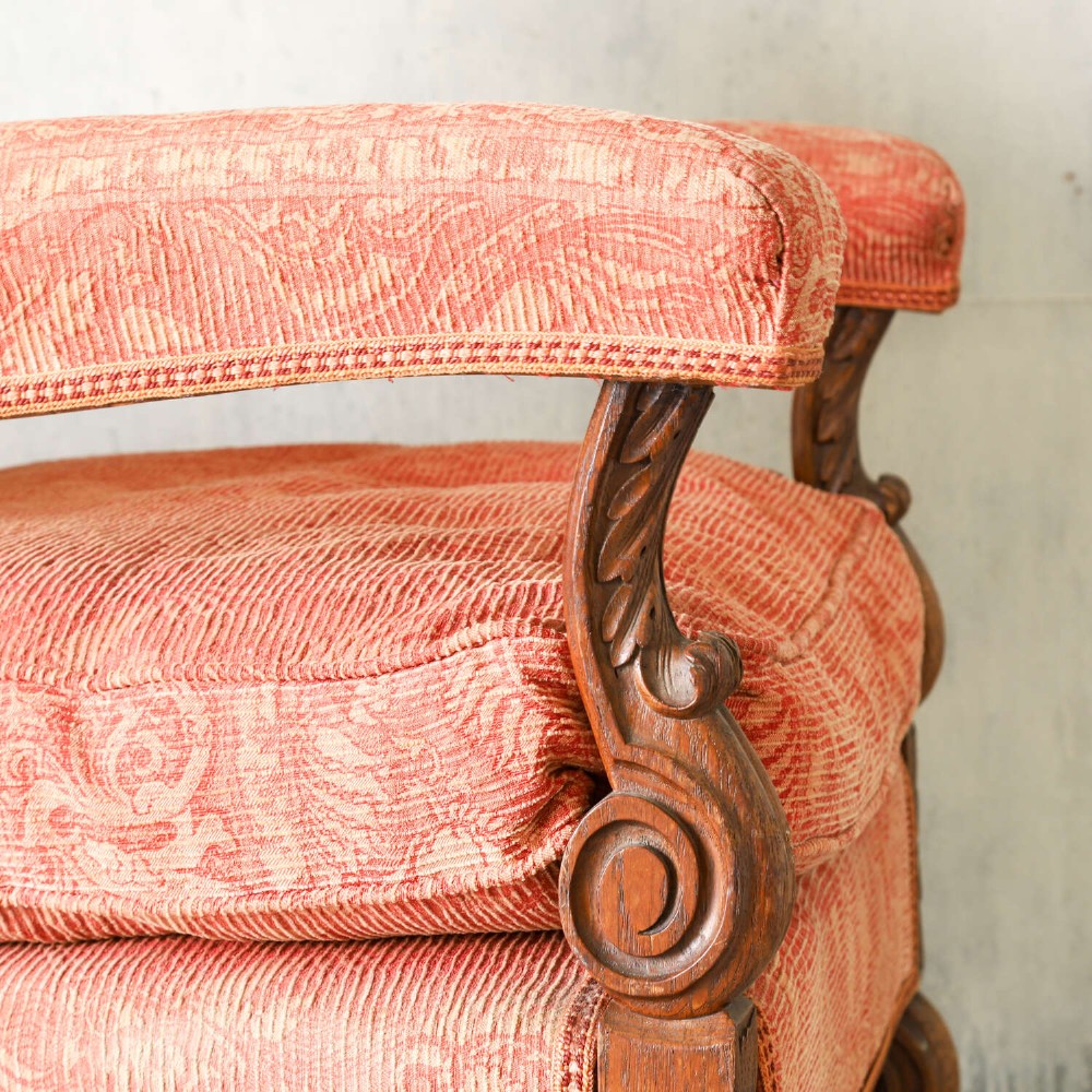 A pair of late nineteenth-century French Renaissance Revival oak armchairs upholstered in terracotta patterned fabric with carved scrolled stretchers and turned legs. View IX