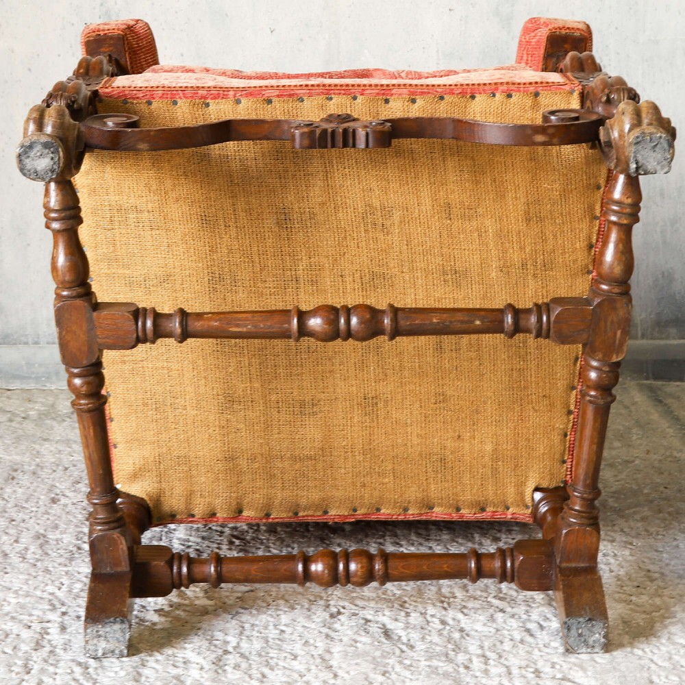 A pair of late nineteenth-century French Renaissance Revival oak armchairs upholstered in terracotta patterned fabric with carved scrolled stretchers and turned legs. View XI