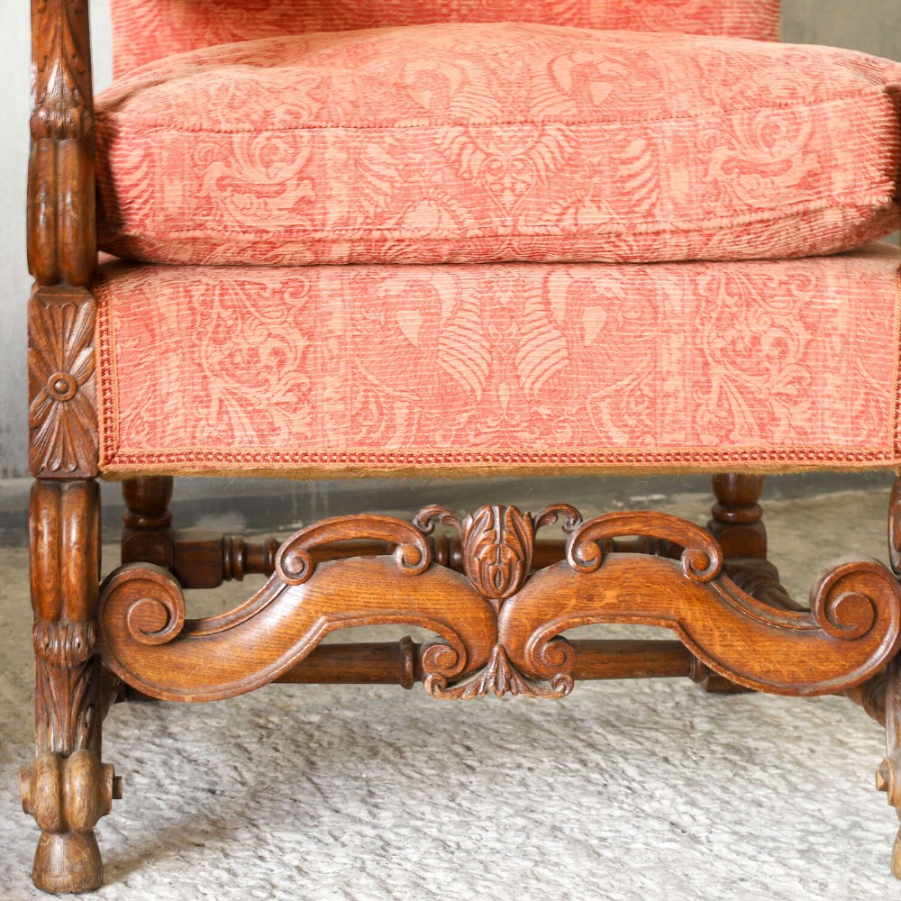 A pair of late nineteenth-century French Renaissance Revival oak armchairs upholstered in terracotta patterned fabric with carved scrolled stretchers and turned legs. View XII