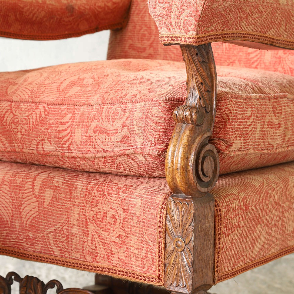 A pair of late nineteenth-century French Renaissance Revival oak armchairs upholstered in terracotta patterned fabric with carved scrolled stretchers and turned legs. View XIV