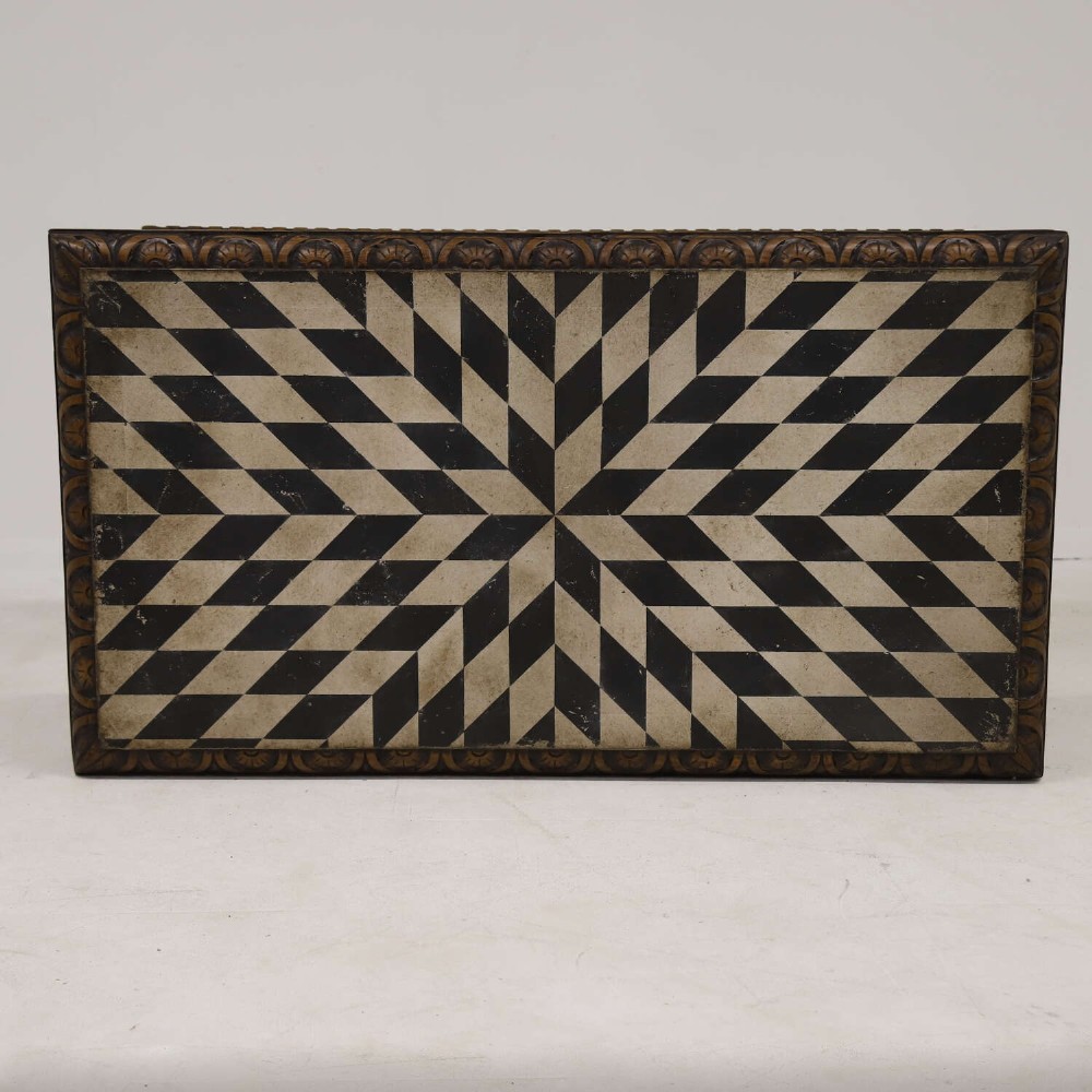 A 19th-century carved oak centre table featuring turned baluster legs, a stretcher base, and a geometric black and white painted starburst top. View X