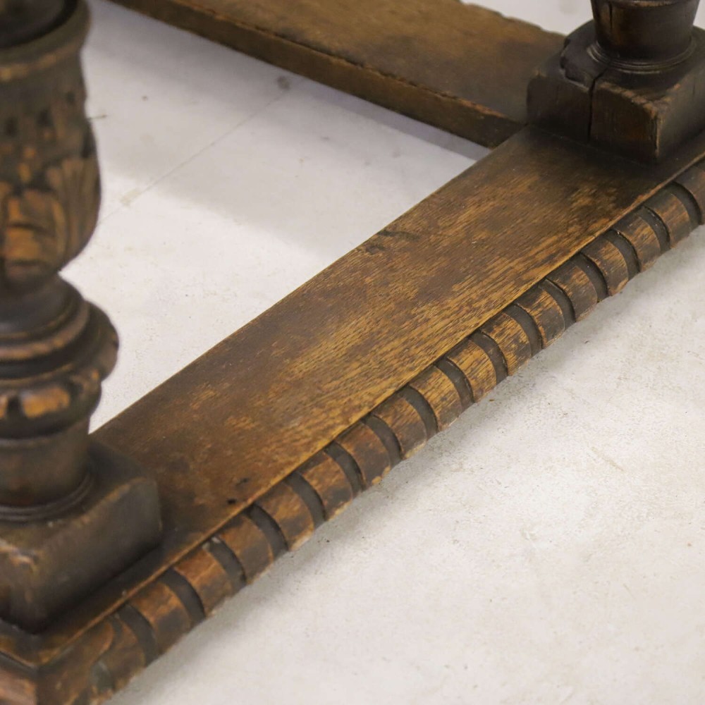 A 19th-century carved oak centre table featuring turned baluster legs, a stretcher base, and a geometric black and white painted starburst top. View XIV