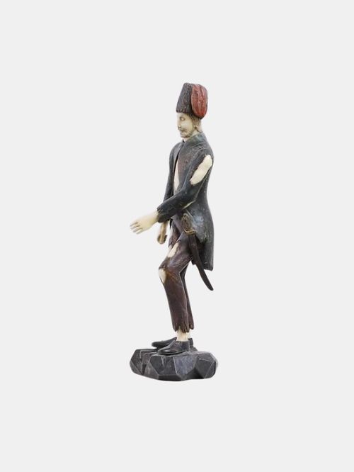 fig 2. An 18th-century carved boxwood and ivory figure of a standing male figure on a naturalistic rocky base.
