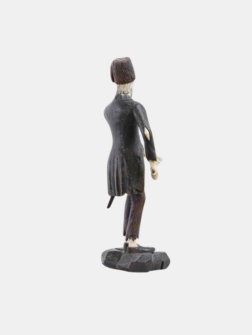 fig 3. An 18th-century carved boxwood and ivory figure of a standing male figure on a naturalistic rocky base.