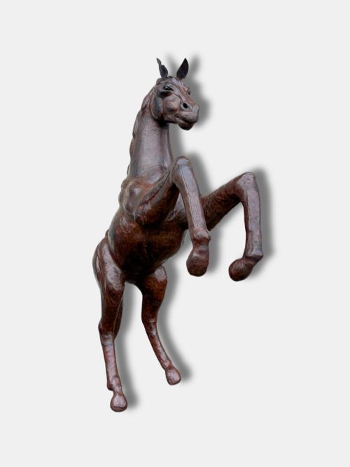fig 1. A large dark brown leather rearing horse sculpture crafted with muscular detailing, mane, and tail.