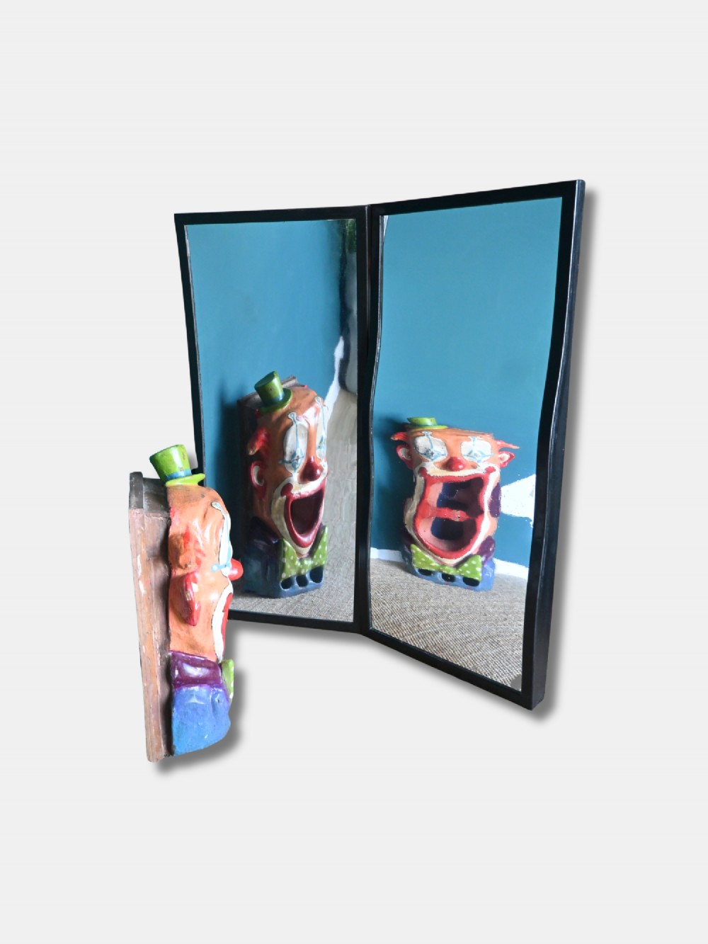A pair of tall rectangular wall mirrors with dark painted wooden frames and distorted curved glass.