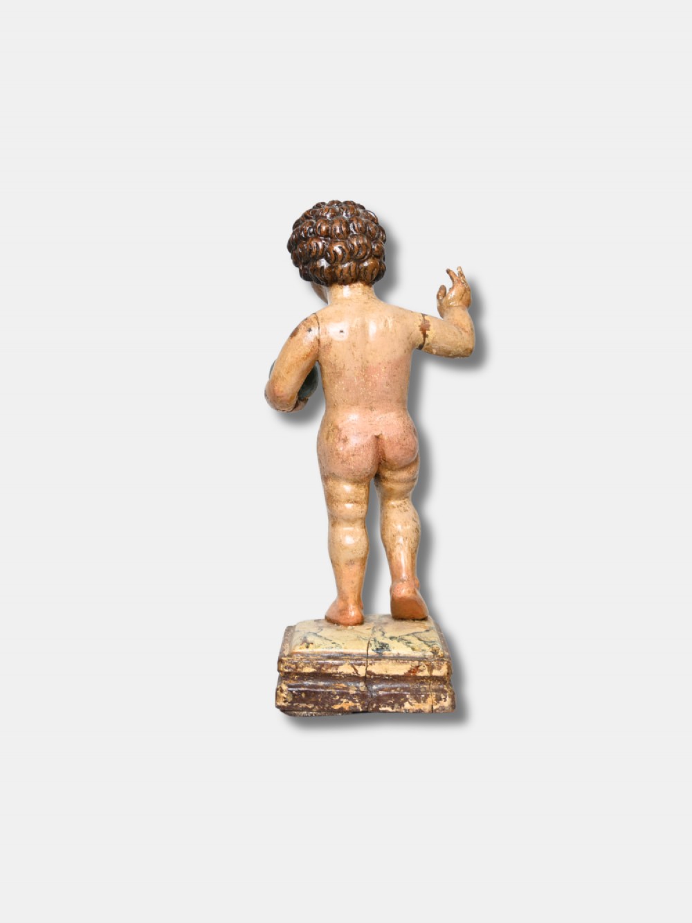A 17th-century Spanish carved polychrome wood sculpture depicting the standing Infant Jesus holding a blue and gold orb in his left hand and raising his right hand in blessing. View III