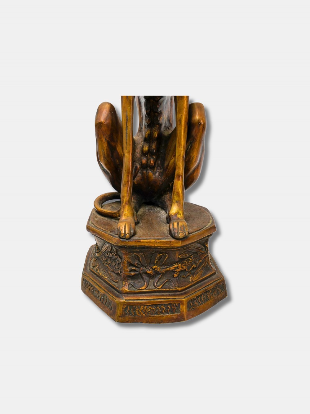 A pair of patinated bronze statues depicting upright seated greyhound dogs resting on relief-decorated octagonal pedestals. View V