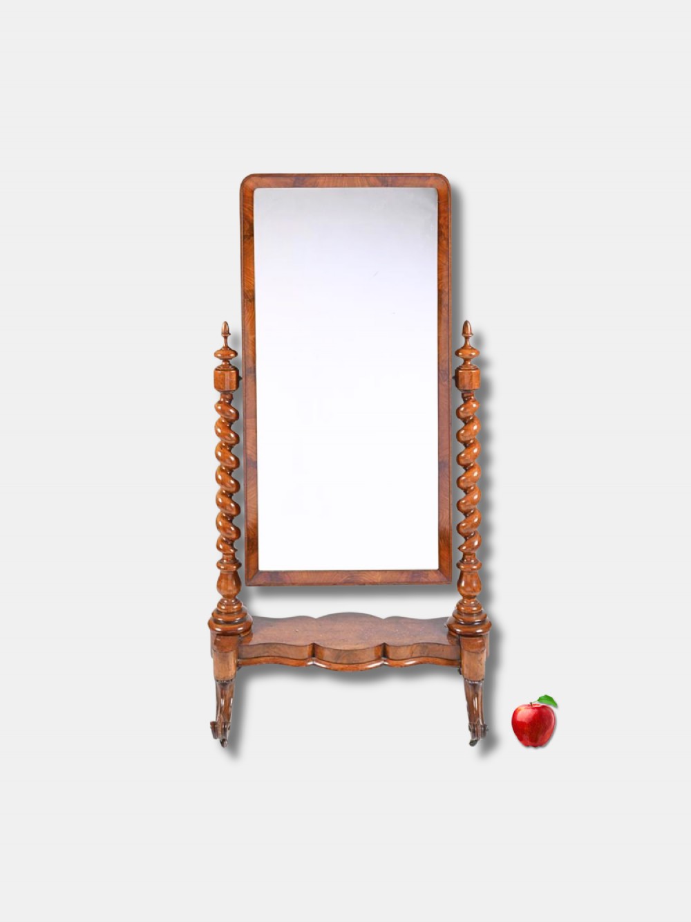 A Victorian warm brown wood cheval mirror featuring barley twist supports, turned finials, and a serpentine plinth base.
