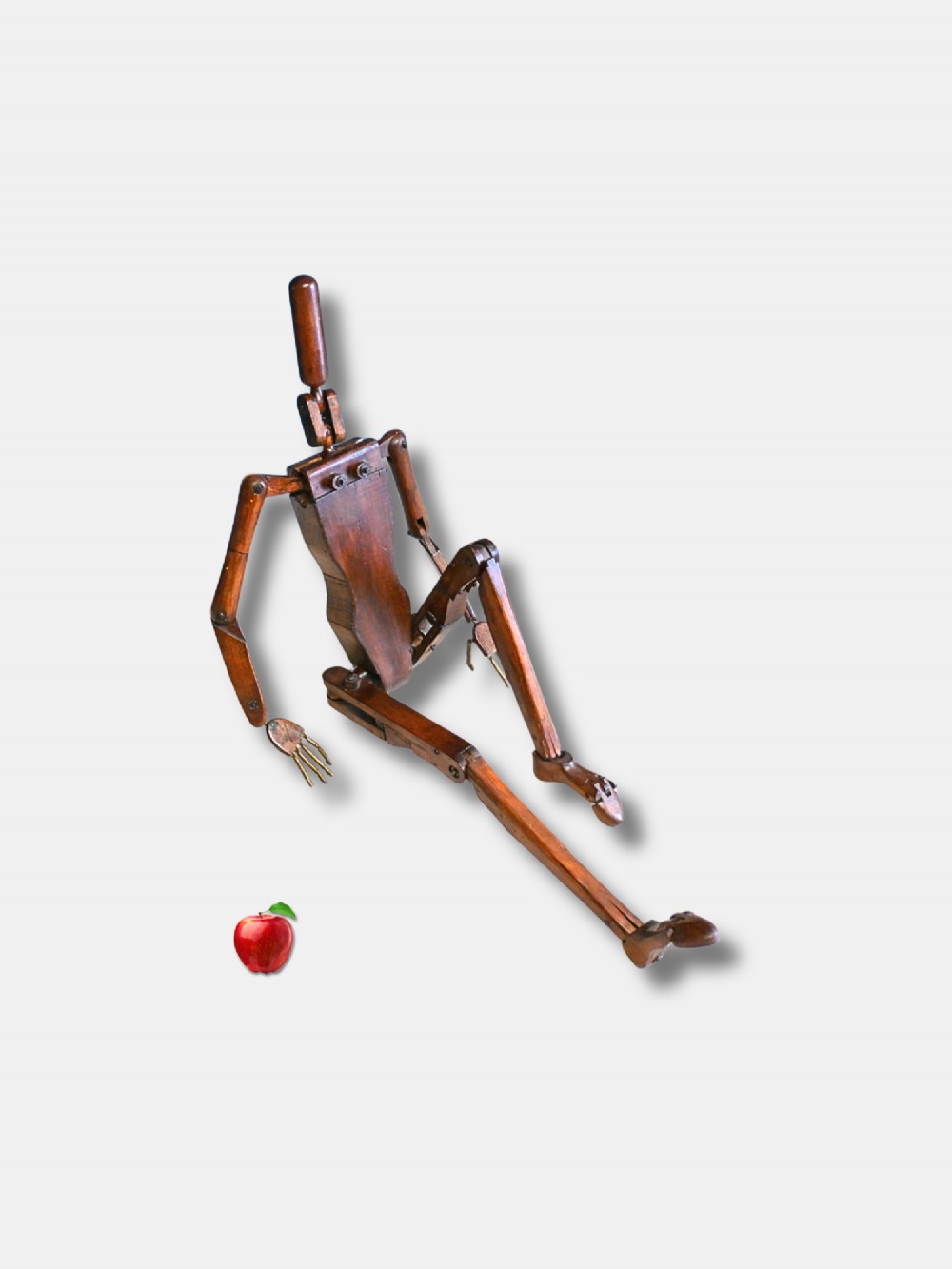 A carved wooden articulated lay figure shown seated with jointed limbs and brass joint fittings. View II