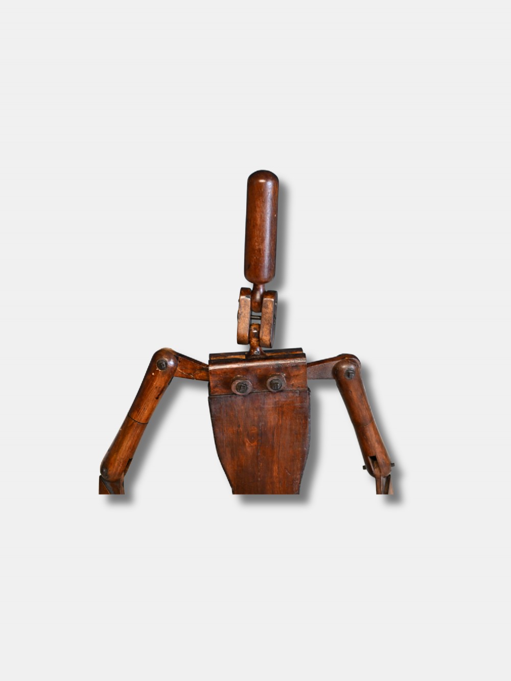 A carved wooden articulated lay figure shown seated with jointed limbs and brass joint fittings. View III