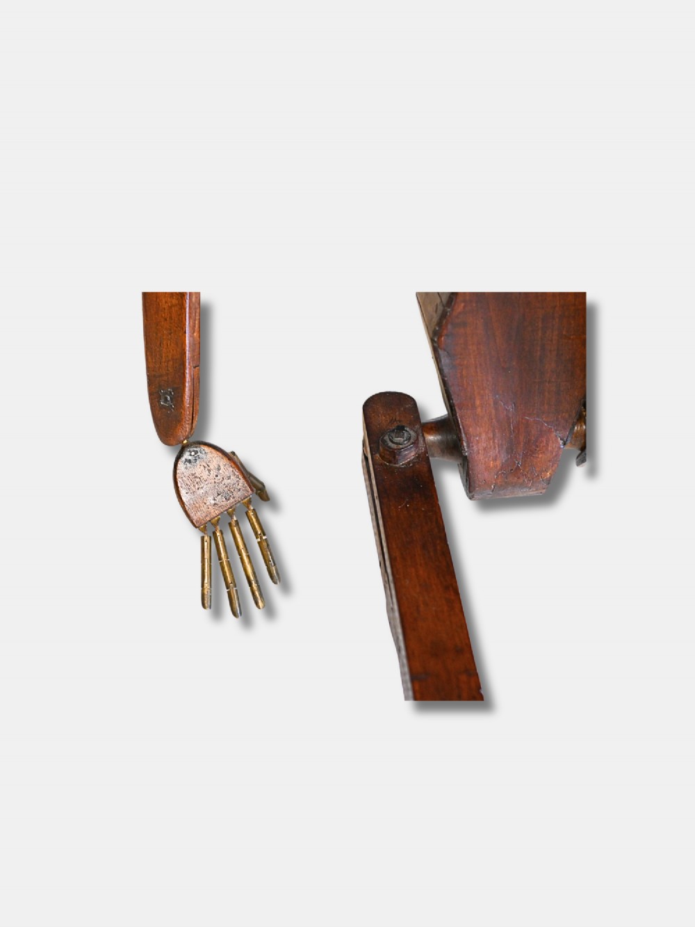 A carved wooden articulated lay figure shown seated with jointed limbs and brass joint fittings. View V