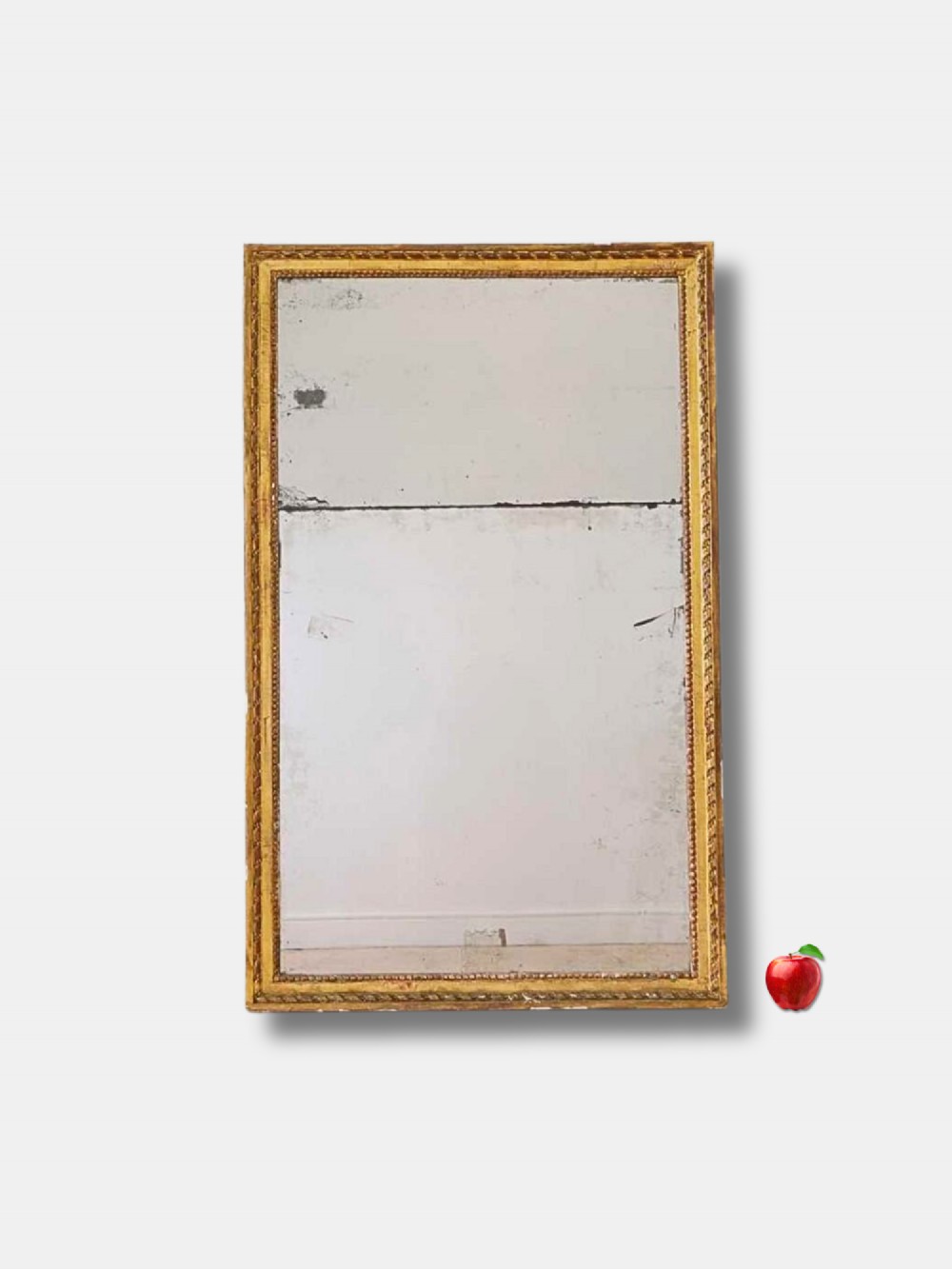 A tall rectangular late 18th-century Louis XVI giltwood pier mirror featuring carved beaded moulding and aged mercury glass plate.