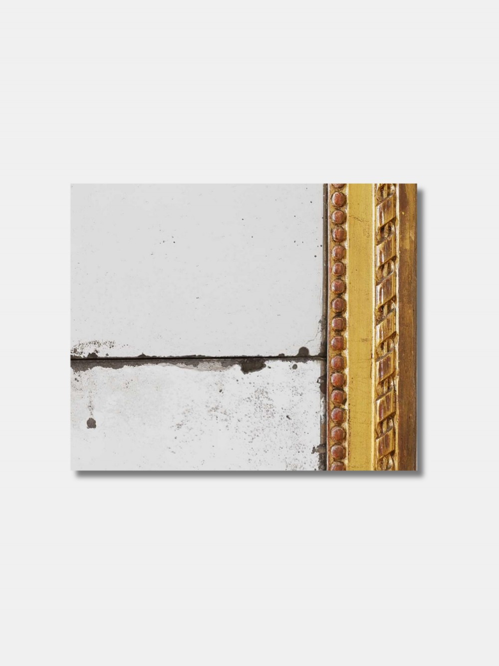 A tall rectangular late 18th-century Louis XVI giltwood pier mirror featuring carved beaded moulding and aged mercury glass plate. View III