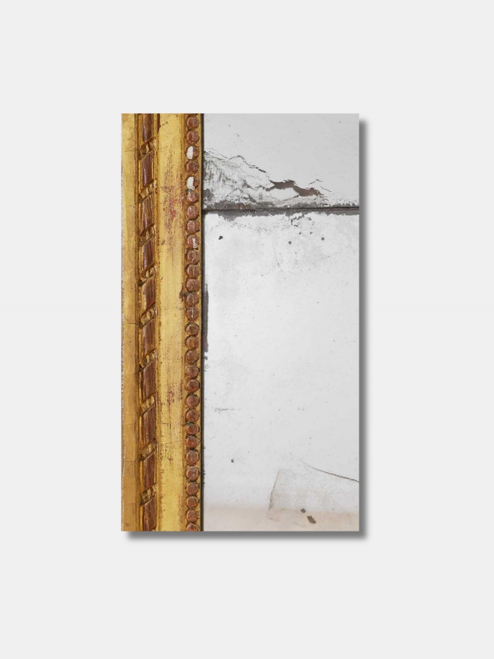 A tall rectangular late 18th-century Louis XVI giltwood pier mirror featuring carved beaded moulding and aged mercury glass plate. View IV