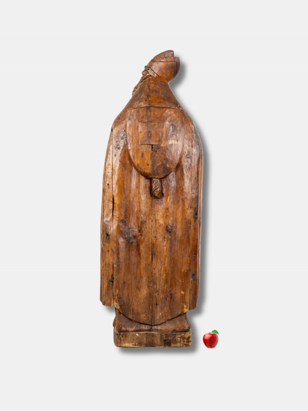 A life-sized 16th-century French carved wood statue depicting Saint Eligius wearing a bishop mitre and draped robes while holding a book. View III