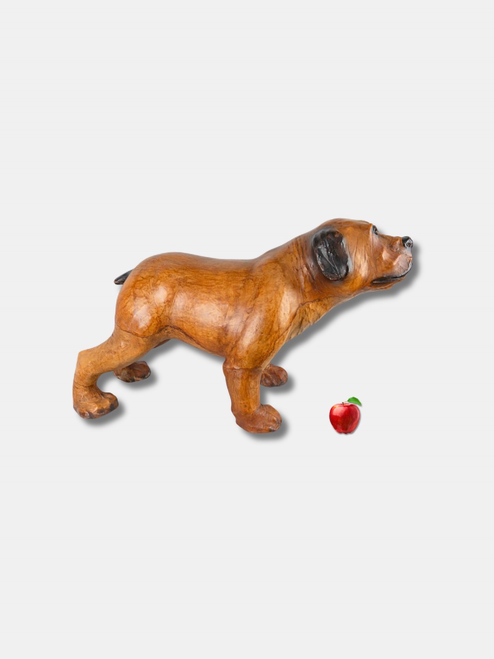 An early twentieth-century handcrafted tan leather footstool shaped as a dog with dark leather ears and muzzle. View II
