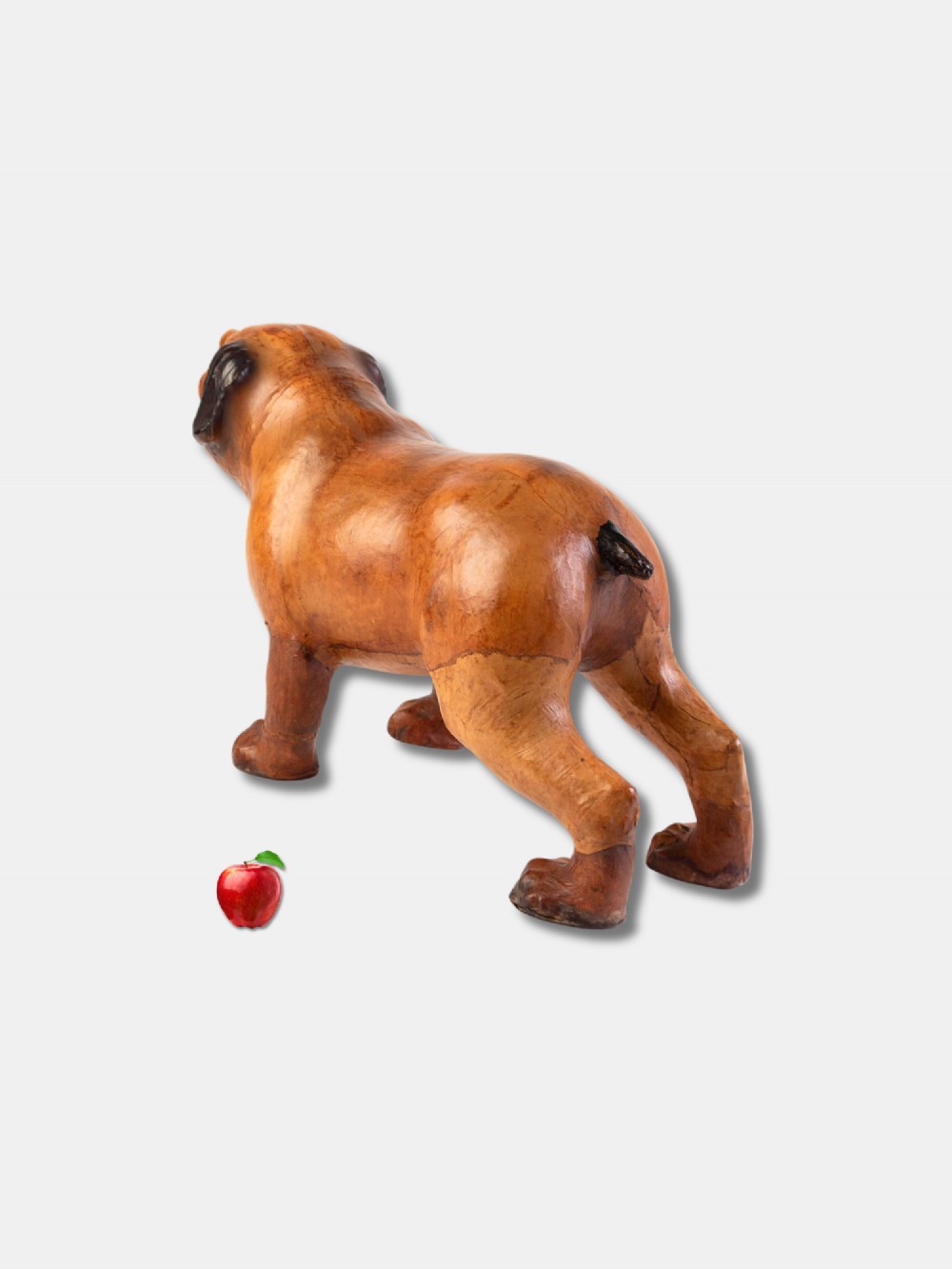 An early twentieth-century handcrafted tan leather footstool shaped as a dog with dark leather ears and muzzle. View III