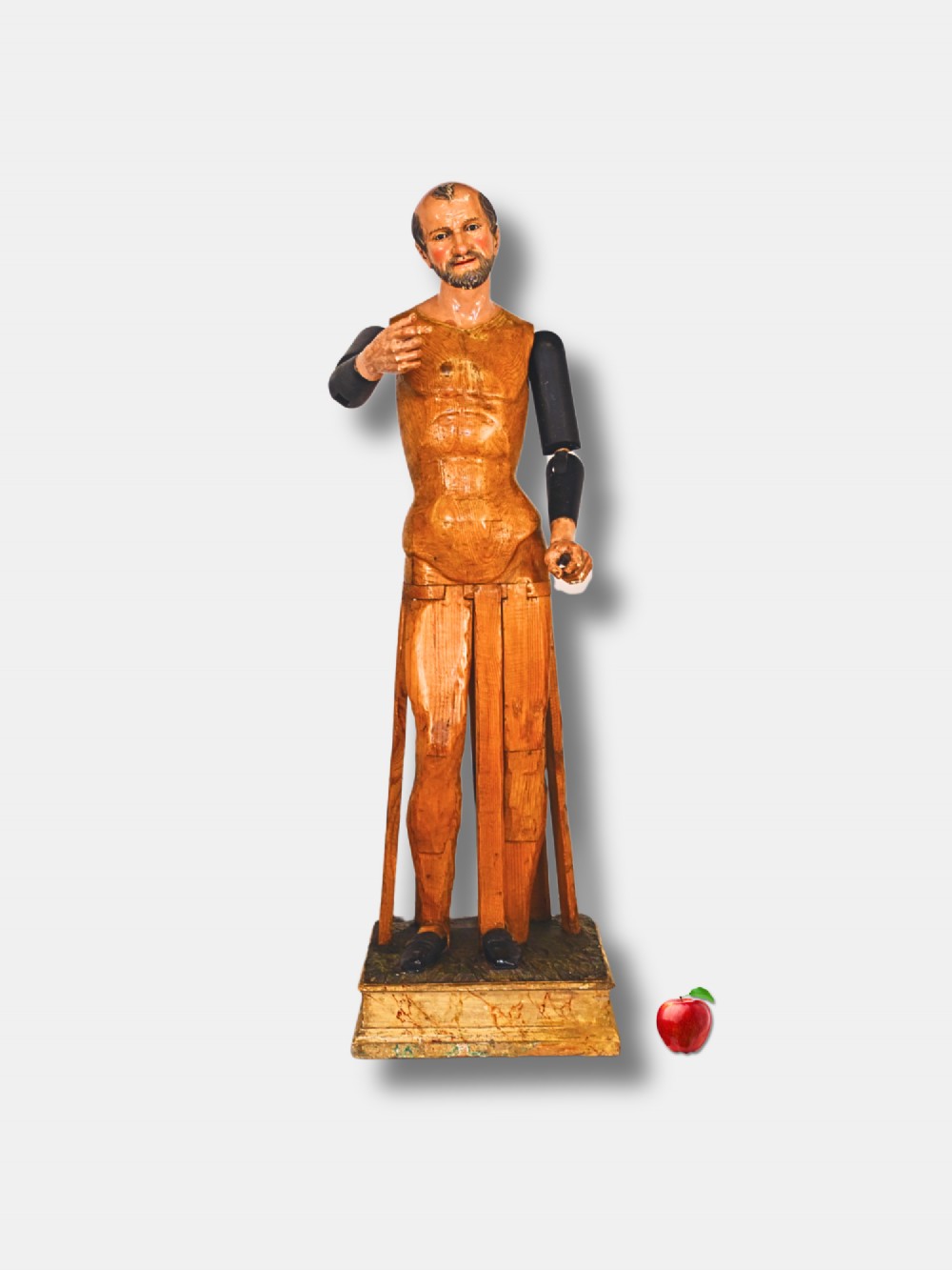 A life-sized 19th-century carved wooden Italian Santos figure with dark articulated arms, polychrome facial features, and a stepped timber base. View II