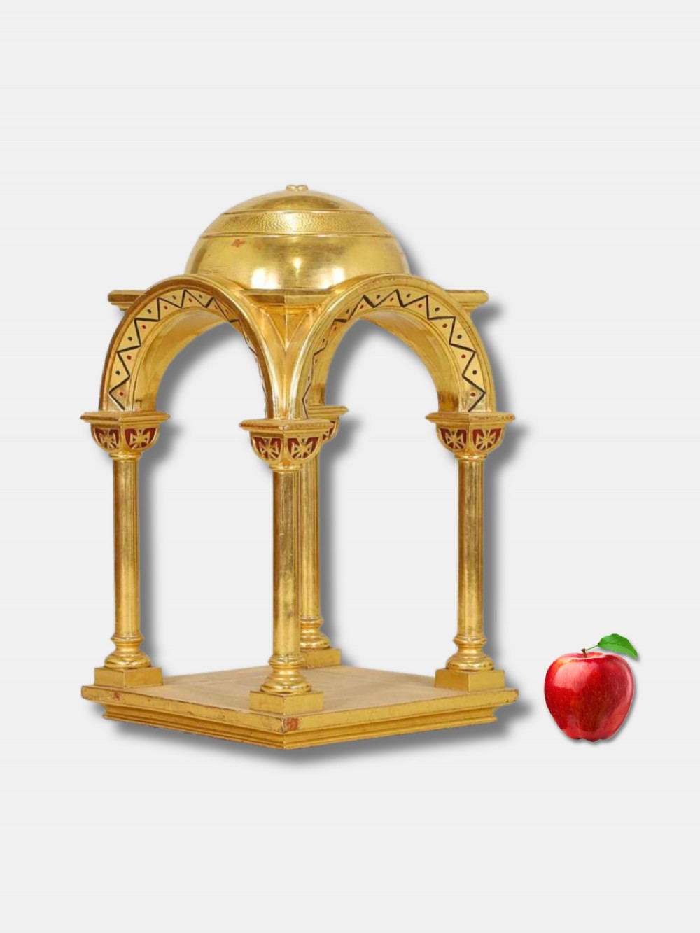 A gilded wooden architectural tabernacle featuring four column supports, painted zigzag archways, and a domed canopy top.