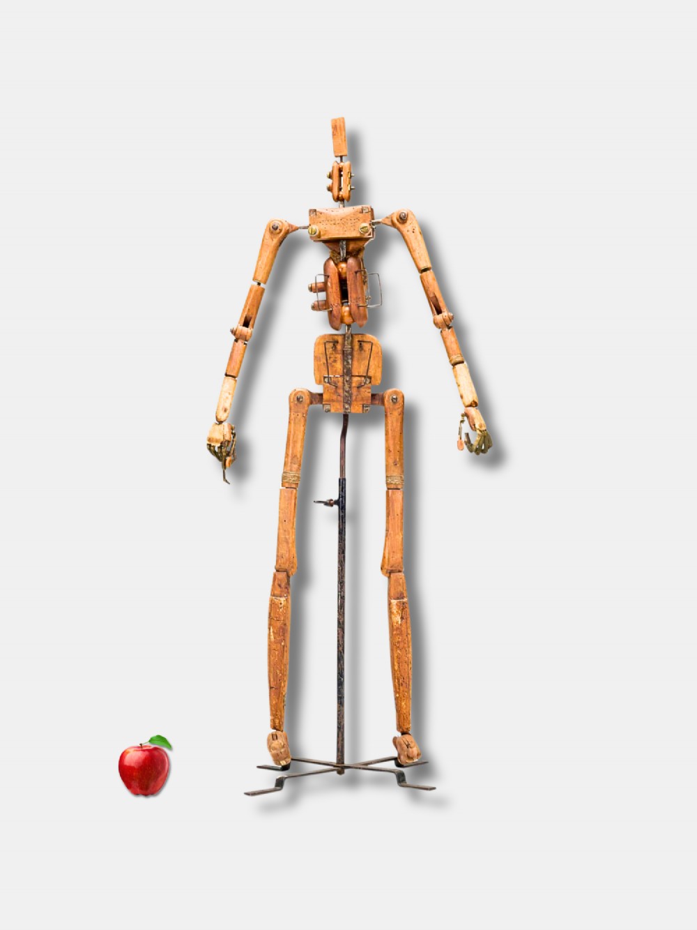 A life-size 18th-century French articulated wooden lay figure with exposed jointed limbs mounted on a dark metal stand.