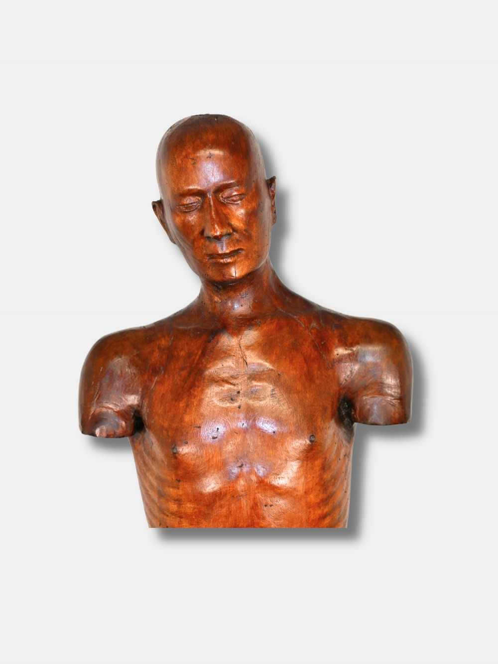 An 18th-century carved wood male figure standing on a square stepped wooden plinth. View II